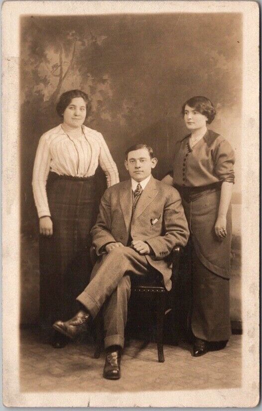 c1910s New York City Studio Photo RPPC Postcard Two Ladies w/ Man in Chair