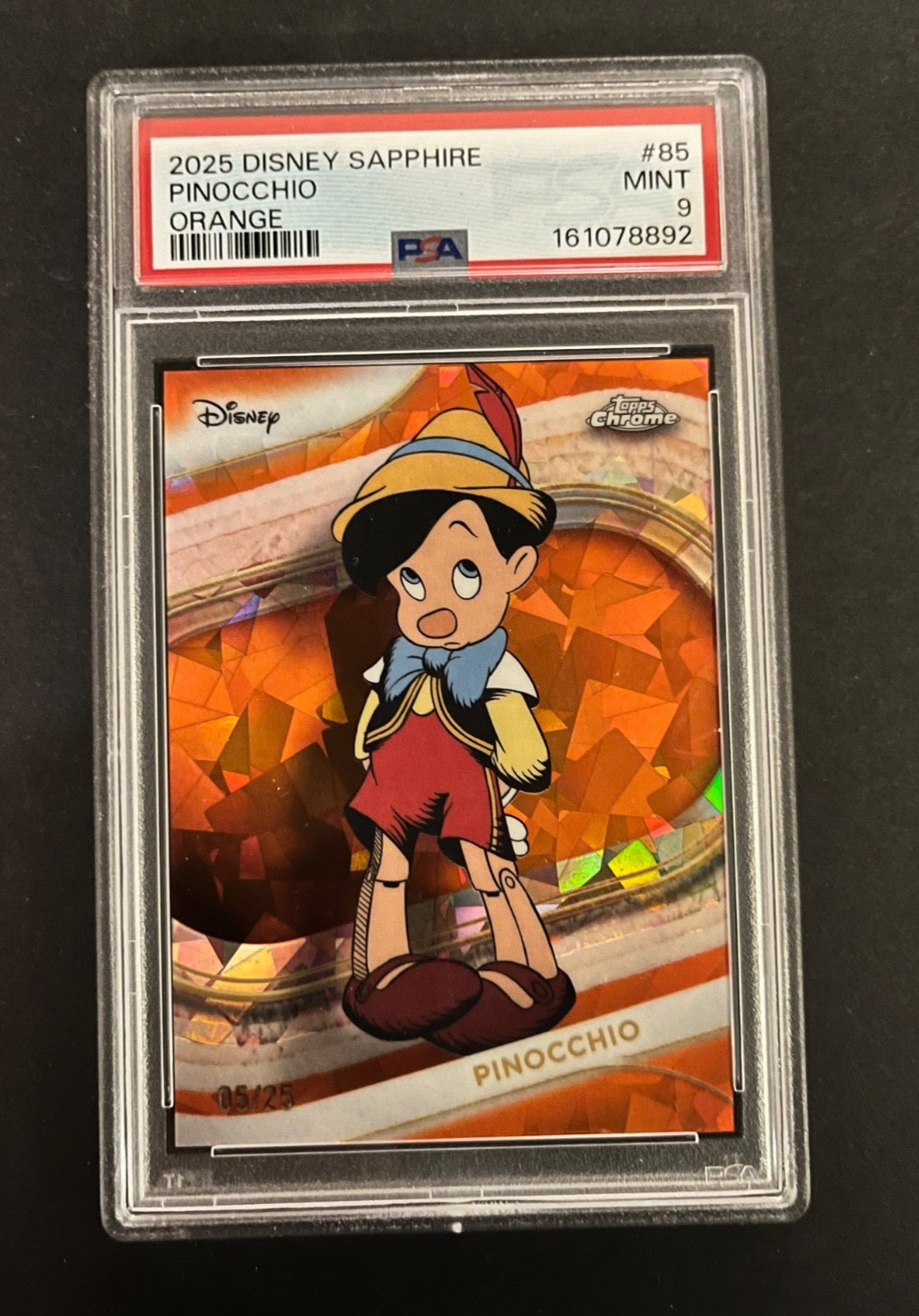 2025 TOPPS CHROME DISNEY SAPPHIRE PINOCCHIO ORANGE  #85 /25 - PSA 9