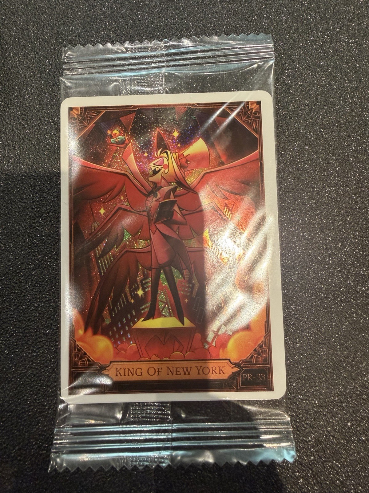 NYCC 2026 PSA HAZBIN HOTEL LUCIFER KING OF NEW YORK PROMO CARD IN HAND