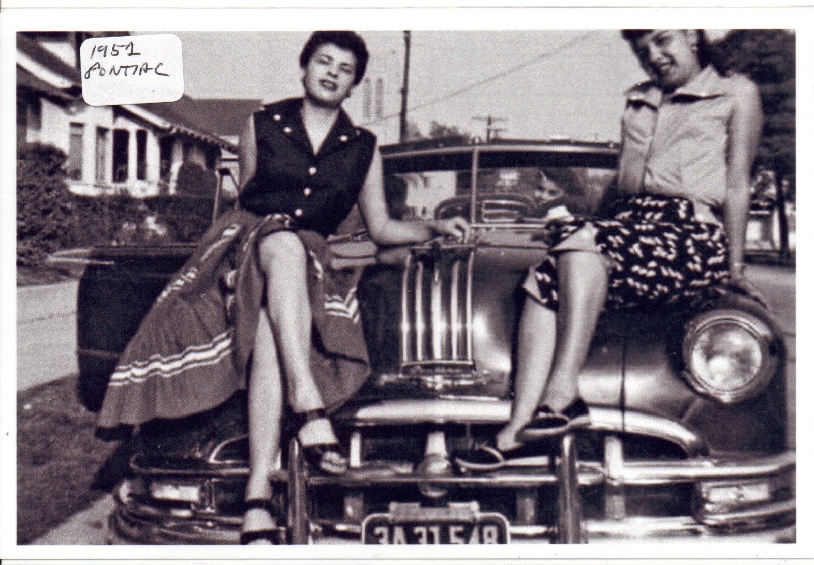 Two Ladies Sitting on a 1952 Pontiac Photo Two Ladies Sitting on a 1952 Pontiac Photo