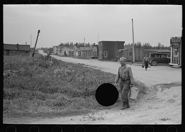 Photo:Minnesota 1937 FSA Man Carrying Bucket Rural Street Scene
