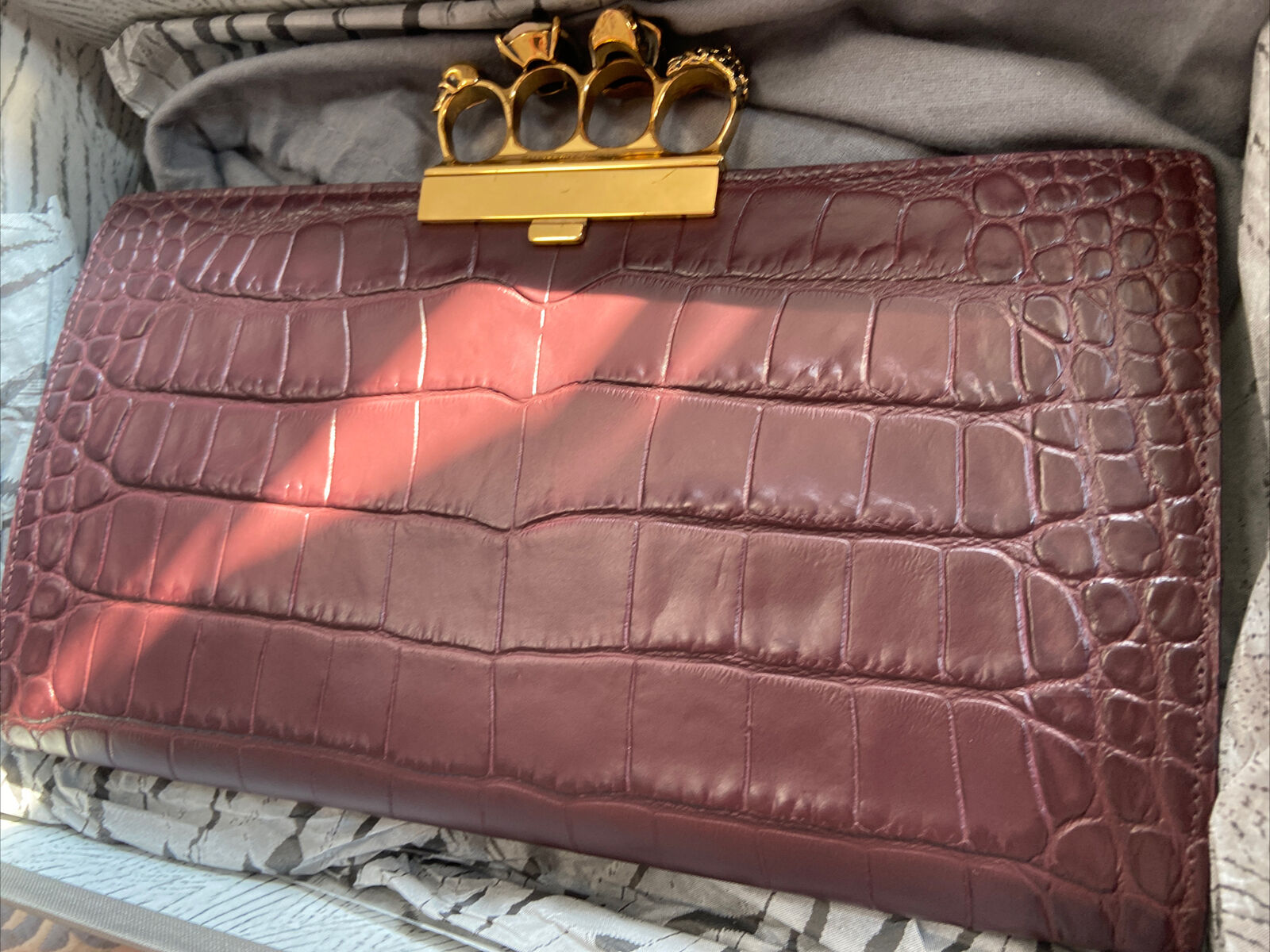 Alexander McQueen Four Ring embossed clutch bag was£1695 burgundy