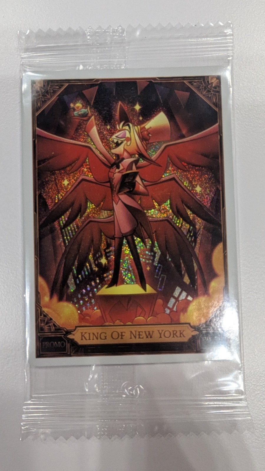 NYCC 2026 PSA HAZBIN HOTEL LUCIFER KING OF NEW YORK PROMO CARD IN HAND