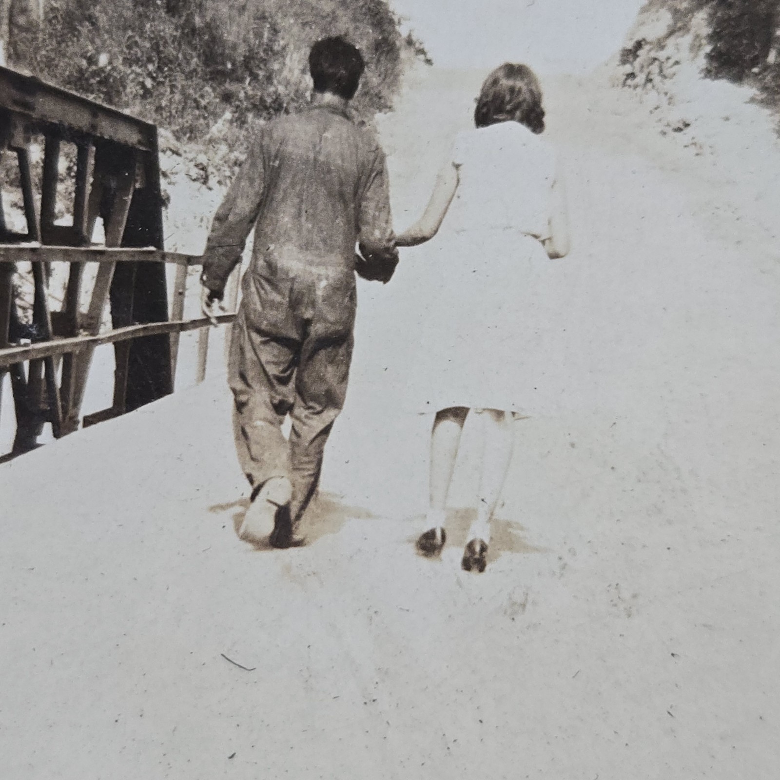 Vintage B&W Photo Snapshot of Couple Holding Hands While Walking Across Bridge