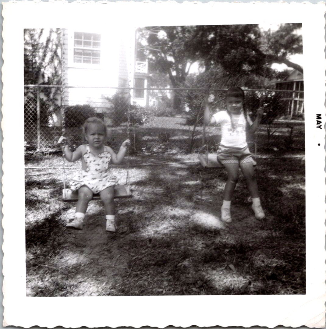 Two Young Sisters on Backyard Swings, 1960s B&W Snapshot Photo