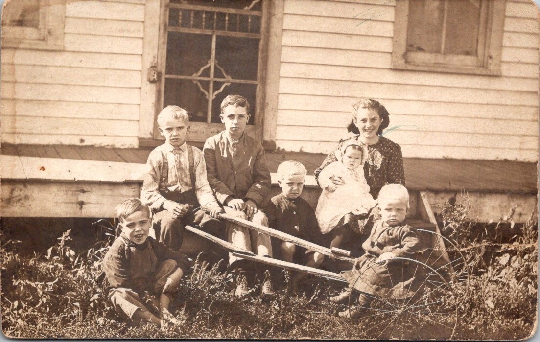 Antique RPPC Real Photo Postcard - 6 Children with Wheelbarrow in Front of House