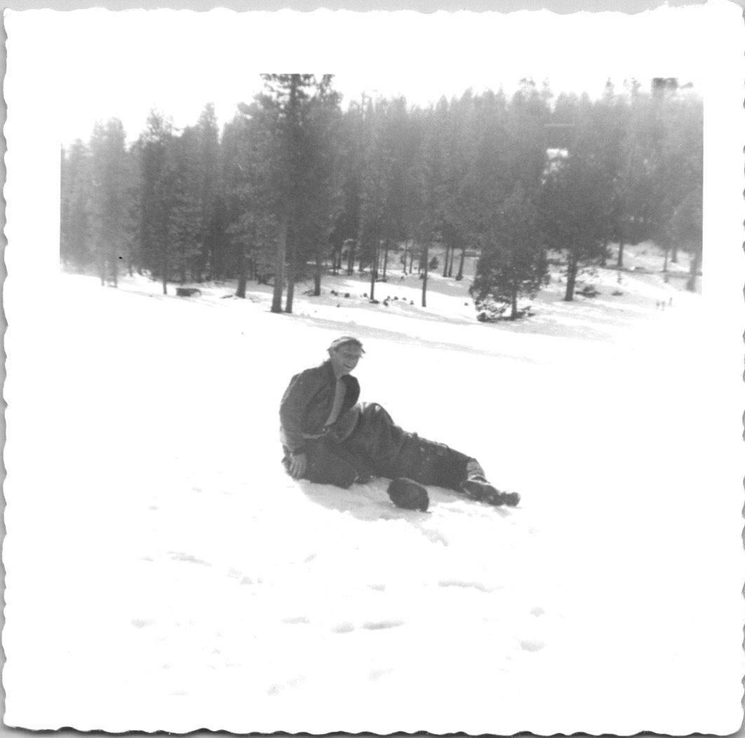 Two guys sitting in the snow laughing Found Photo V0896