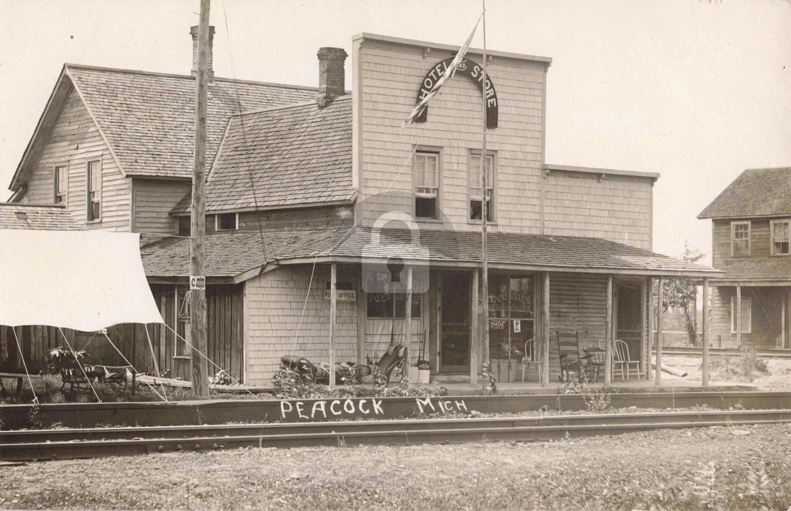 Railroad by Hotel, Store & P.O., Peacock MI Michigan RPPC Photo Postcard COPY
