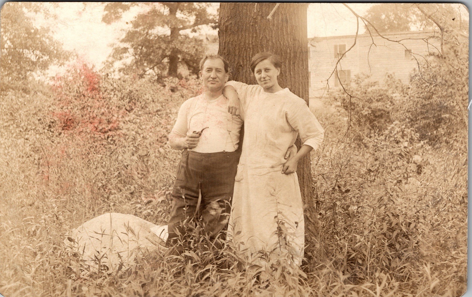 Postcard Real Photo RPPC Man Holding Pipe Standing Next to Woman Next to Tree