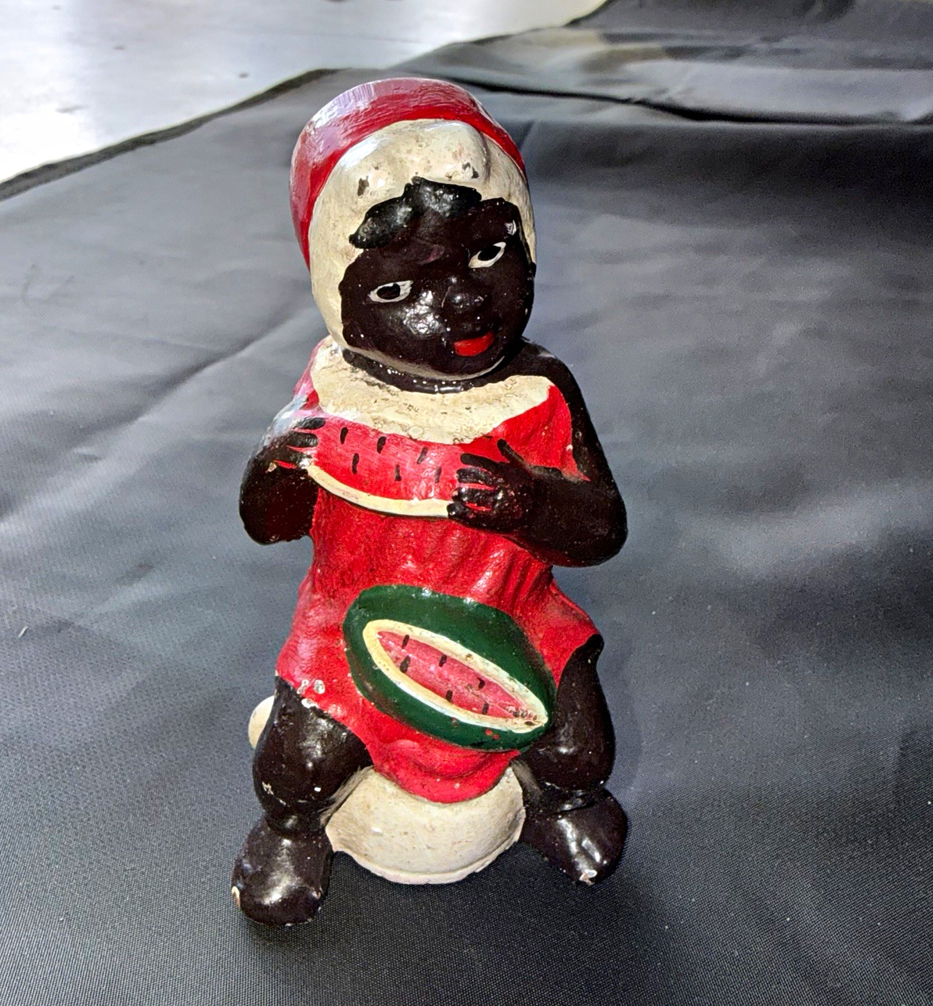 Vintage cast iron girl eating watermelon