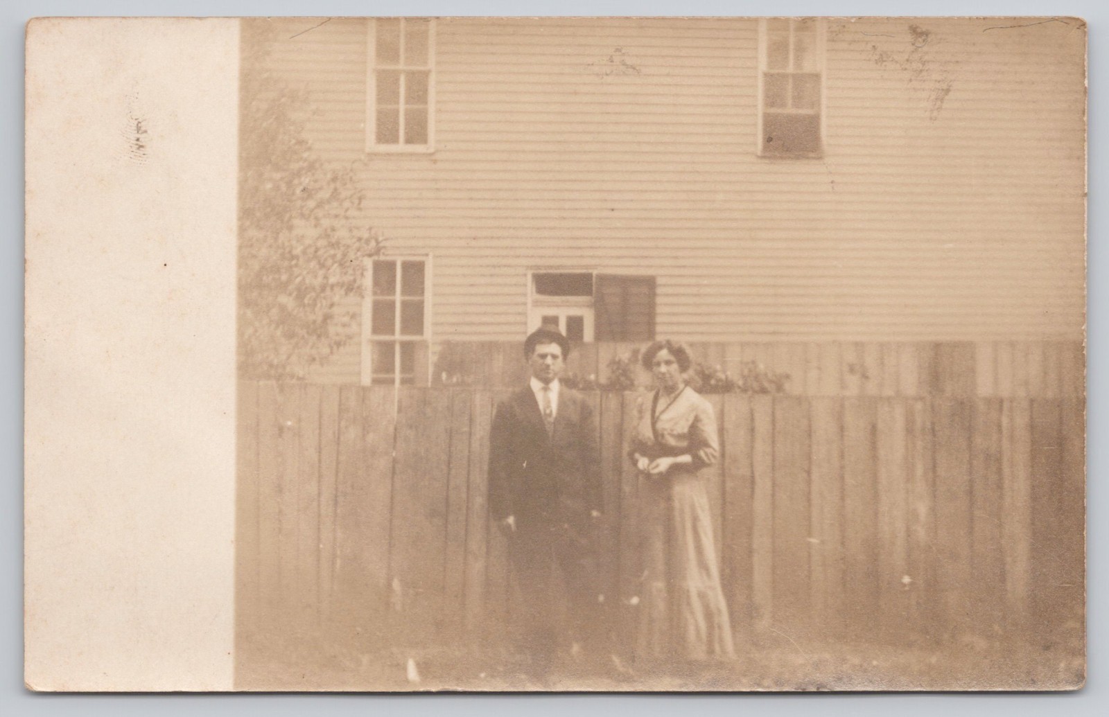 RPPC Family Portrait Couple Standing Fence House Early 1900s Real Photo Postcard