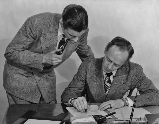 Two men checking a document in the office circa 1940\'s Historic Old Photo