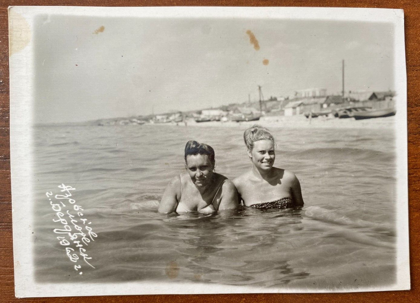 Affectionate gentle girls in swimsuits on the beach posing, Vintage photo