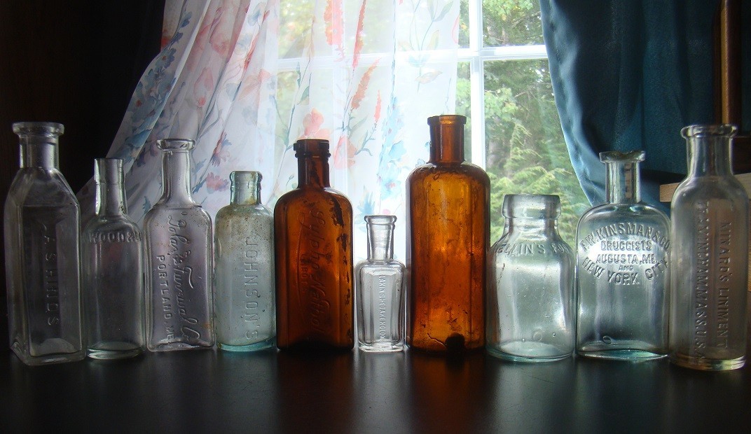 TEN PIECE EMBOSSED ANTIQUE MEDICINE BOTTLE LOT