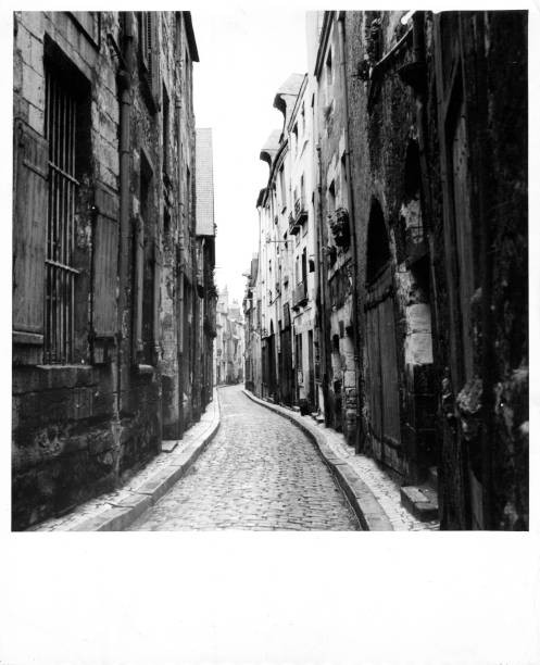 Long narrow stone street old large buildings each side of road Rog- Old Photo