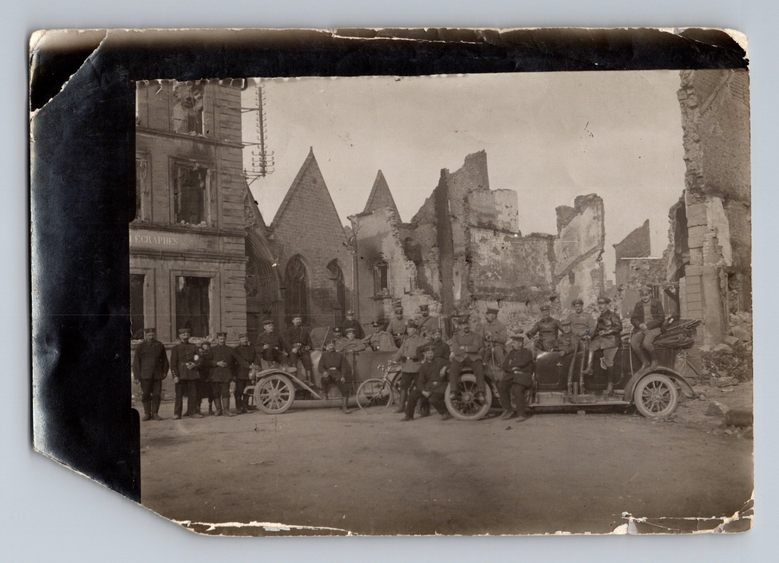 WWI German Infantry Regiment Sits on Cars in Demolished French Town Photo 1914