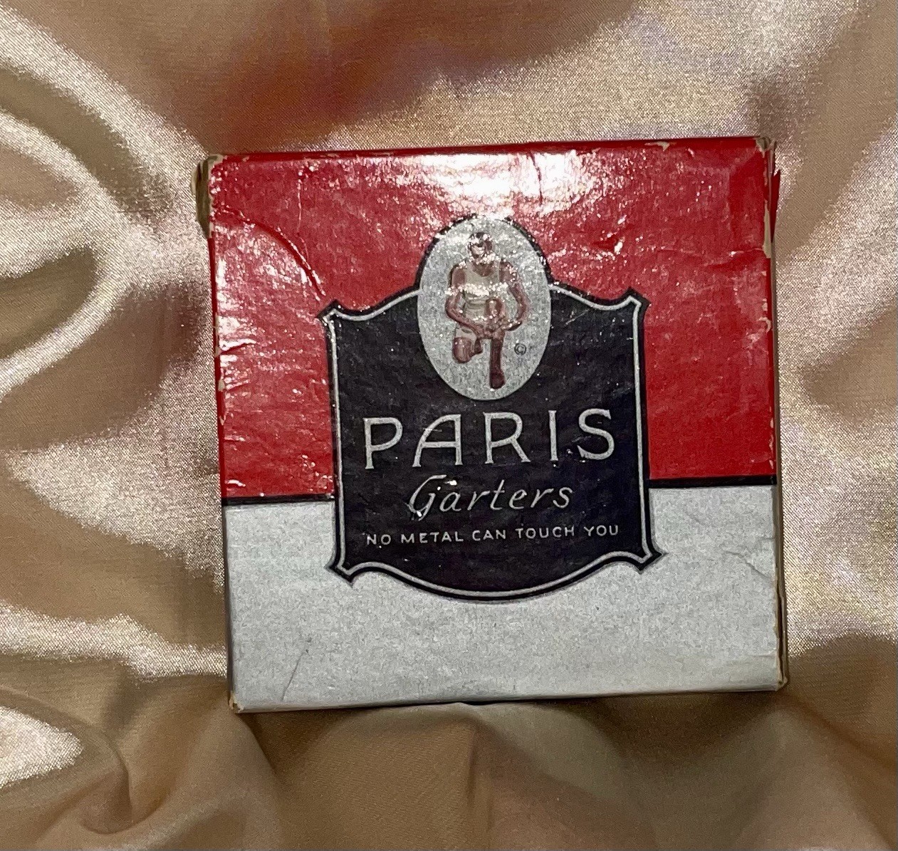 An Empty Vintage Red and Gray Advertising Box For Paris Menswear Garters.