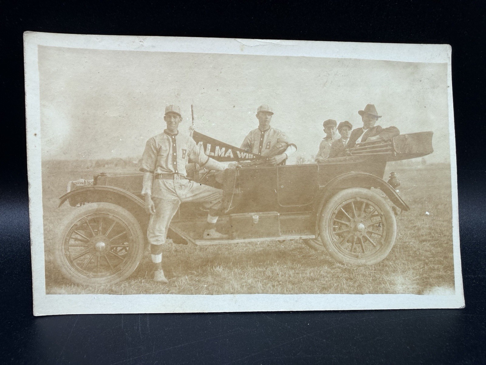 Alma Wisconsin Baseball Players holding flag  in Truck Postcard Era 1916