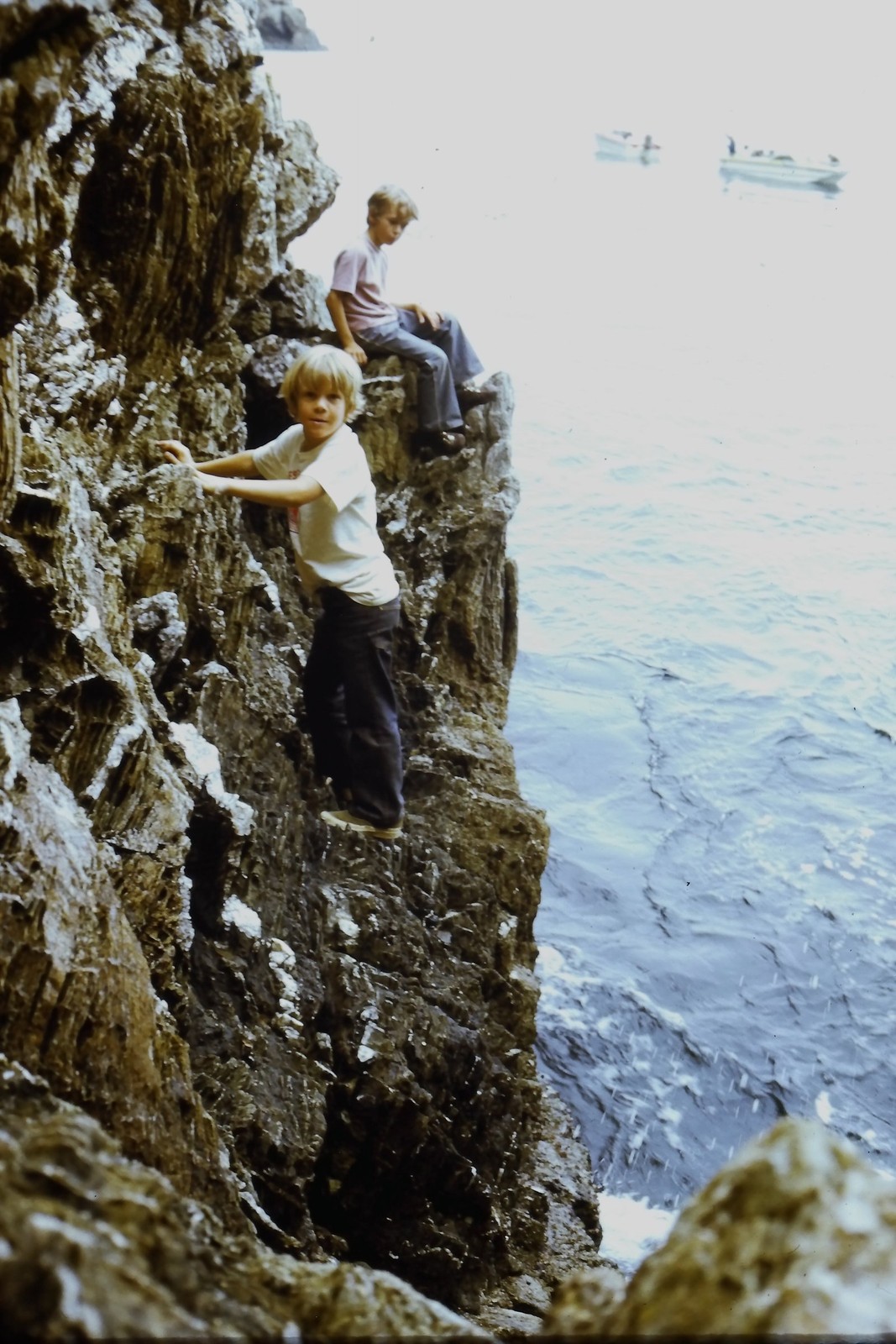 c1970\'s Kodachrome 35mm Slide, Boy Climbing Rocky Cliff Ocean Water blue