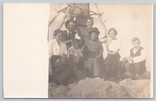 Vintage RPPC Postcard Group of 7 People Outdoors Wooden Structure c. 1910s AZO picture