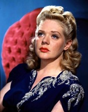 US screen star Alice Faye wearing a smart blue top whilst sitting - 1953 Photo picture
