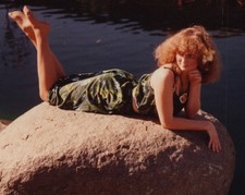 1980s Pretty Woman Curly Hair Flower Hair Reclining Rock Pond Fashion Portrait picture