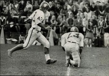 1965 Press Photo Football players on the field watched by spectators during game picture
