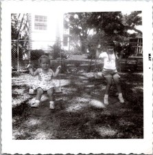 Two Young Sisters on Backyard Swings, 1960s B&W Snapshot Photo picture