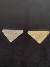 A Set Of Two Prada Brooch Pins For Classy Occasions. picture