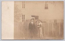 RPPC Family Portrait Couple Standing Fence House Early 1900s Real Photo Postcard picture