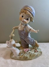 VTG Porcelain Boy Figurine w/ White Dog & Scooter. 10.5” T x 8.5” W. Gold Trim.  picture