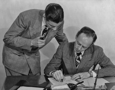 Two men checking a document in the office circa 1940's Historic Old Photo picture