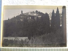 Postcard Buildings on Tree-Covered Hill With Tower and Distant Mountain View picture
