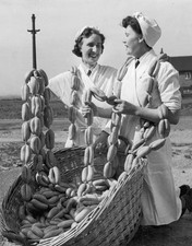Two women selling strings of sausages from a huge basket Old Photo picture