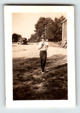 Photo Man In Fedora Hat Walking Near Vintage Cars By Barn Vintage 1930s picture
