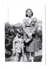 B&W Photo Snapshot Mother holding little boys hand while he smirks at camera picture