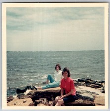 Vtg Color Snapshot Two Women Friends Sitting On Rocky Shore Ocean Beach Water picture